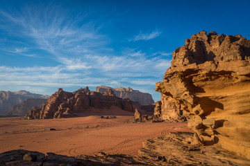 Bedouin camps from a distance in wadi rum with panoramic view and stones