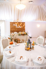 banquet table is decorated with plates, cutlery, glasses, candles and flower arrangements