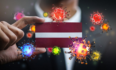 Corona Virus Around Latvia Flag. Concept Pandemic Outbreak in Country