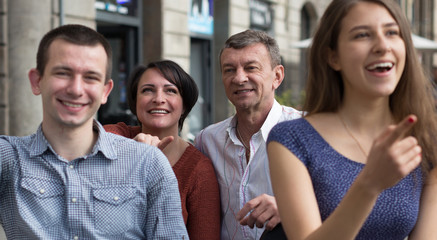 family of tourists enjoy a walk on the bike carriage