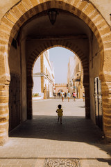 little girl crossing a door