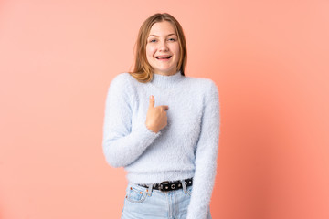 Teenager Ukrainian girl isolated on pink background with surprise facial expression