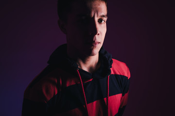 Young Man in a Jumper Dancing Contemporary Dance in Studio. Breakdancing. Dance School Poster. Copy Space. Battle competition announcement. Pink and Blue Background.