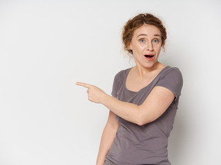 surprised young woman pointing at something