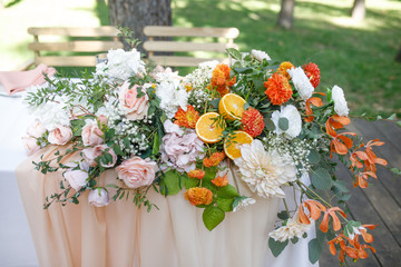 banquet table is decorated with plates, cutlery, glasses, candles and flower arrangements