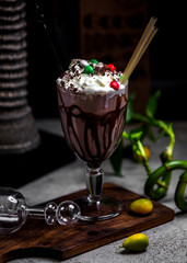 chocolate milkshake with whipped cream and candies on top
