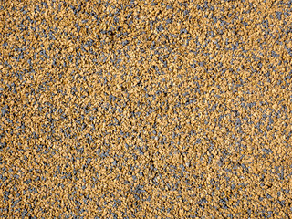 Gravel texture. Background golden gravel surface.