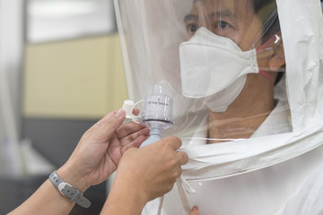 Respirator fit test prepared for COVID-19. Asia doctor testing repiratory system with N-95 surgical...