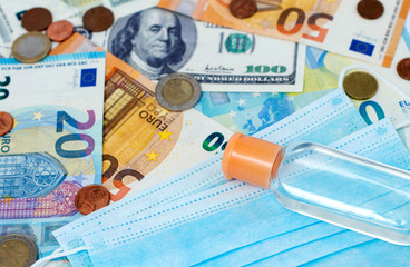 Medical masks and money, antiseptic, close-up. Coronavirus concept. The fall of the global economy.