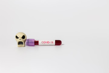 Coronavirus disease COVID-19 infection can cause death,COVID-19 blood sample test tube and skull on...