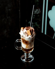 coffee drink with whipped cream and cookies