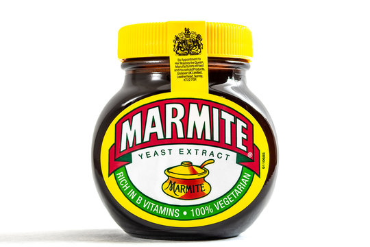 London, UK - August 10 2018: An unopened jar of Marmite over a plain white background with copy space and a clipping path cutout. Marmite is a yeast spread product