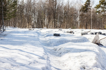 Old tires from cars and trees. Paintball territory in the forest. Background for advertising