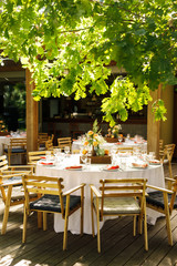 banquet table is decorated with plates, cutlery, glasses, candles and flower arrangements