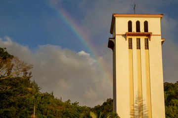 tower of the church and rainbow
