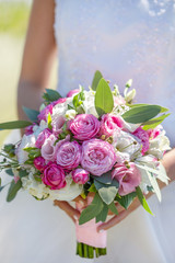 Bridal bouquet of fresh flowers. Wedding concept. Wedding bouquet in the hands of the bride. Beautiful flowers. Spring.Romantic. Photos for florists