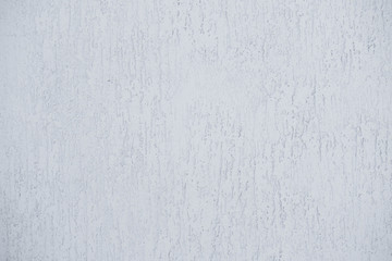 Light gray wall with embossed surface made of concrete. Gray background.