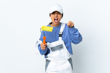Painter woman over isolated white background frustrated and pointing to the front