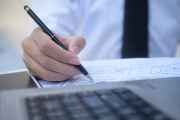 Man drawing on document to planing job work on desk