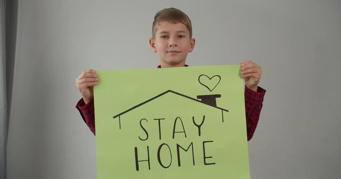coronavirus quarantined boy holds a sign stay home save lives