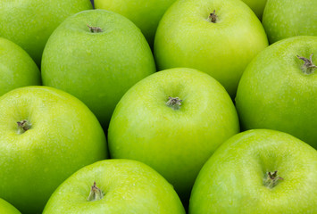 Many fresh green apples as background