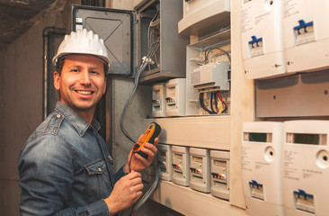 Portrait  Male Electrician Standing In Front Of electric panel