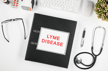 Doctor's workspace, in the center is a folder with the inscription: lyme disease