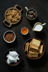 Ingredients for cooking vegetarian chocolate salami with coconut butter and milk, and Jerusalem artichoke syrup. Flat lay
