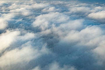 Clouds from above from an airplane on a sunny day.