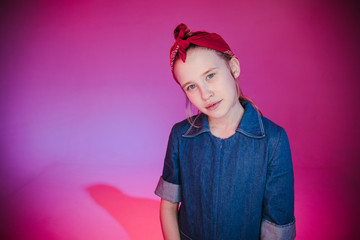 Young stylish girl in the Studio on a colored neon background. Music dj poster design. Portrait of a young girl dancer.