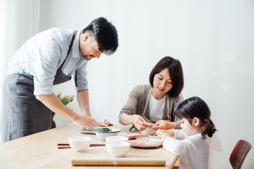 Mom and Dad and daughter at home dumplings