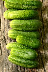 Fresh cucumbers on a wooden table close-up.