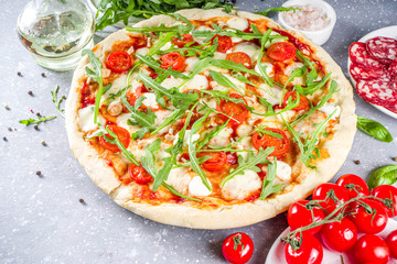 Flatbread homemade vegan pizza. Italian classic pizza with tomato cherry, mozzarella cheese and fresh arugula, copy space