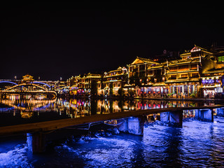 Fototapeta na wymiar fenghuang,Hunan/China-16 October 2018:Tourist walking with beautiful Scenery view in the night of fenghuang old town .phoenix ancient town or Fenghuang County is a county of Hunan Province, China
