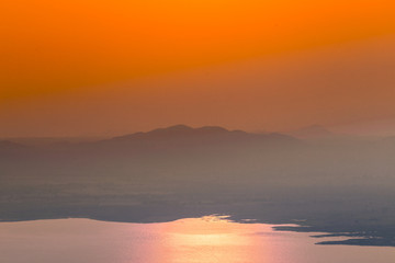 Natural blurred natural background, high angle viewpoint area, overlooking trees and mountains and large windmills,abundance of forests