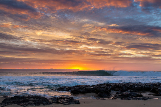 sunrise over waves rolling into super tubes at Jeffrey's bay