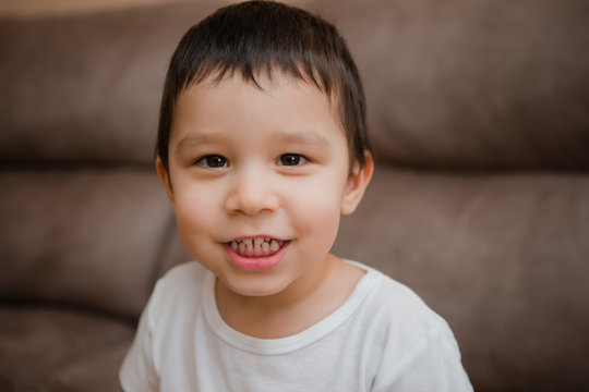 Toddler Boy Brunette Plays At Home on the Couch - Powered by Adobe