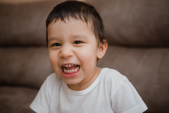 Toddler Boy Brunette Plays At Home on the Couch - Powered by Adobe