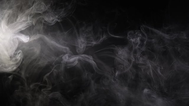 Texture of cigarette white smoke on a black background. Slow motion.
