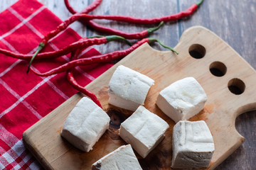 fresh white tofu on wooden table