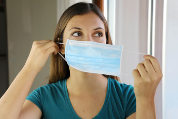 COVID-19 Pandemic Coronavirus Woman Wearing Mask Against Virus SARS-CoV-2. Girl wearing surgical...
