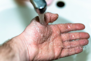 Fototapeta premium Male hand. Hand washing with water in the sink.