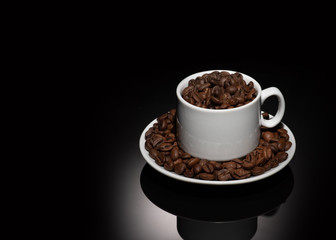 Cup with coffee beans on a dark background