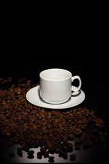 Cup with coffee beans on a dark background