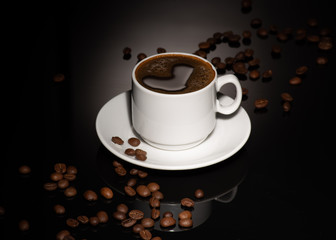 Cup with coffee beans on a dark background