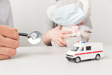 Doctor and kid sitting in the cabinet with ambulance