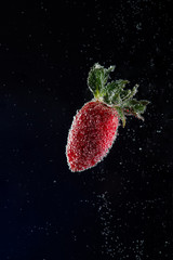 strawberry falling into water