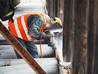 Welding work ,worker with protective welding metal on construction