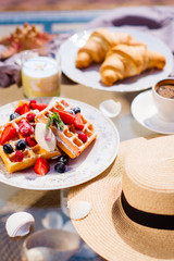 Waffles for breakfast with fresh berries and coffee
