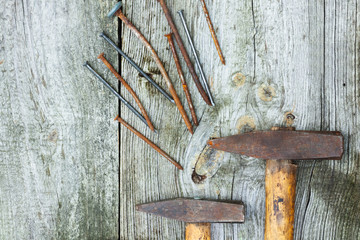 Set of vintage hand construction and carpentry tools hammers on a old wooden background, retro concept .